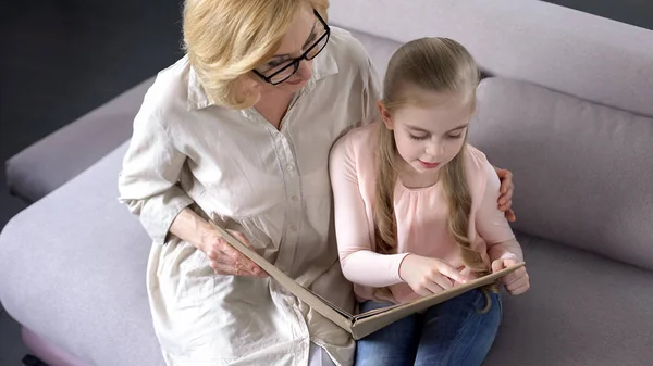 Happy Blond Granddaughter Reading Book Her Caring Grandmother Togetherness — Stock Photo, Image