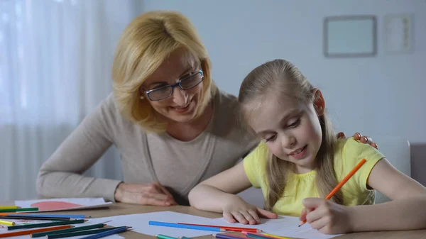 Caring Retired Woman Looking Cute Granddaughter Painting Colored Pencils — Stock Photo, Image