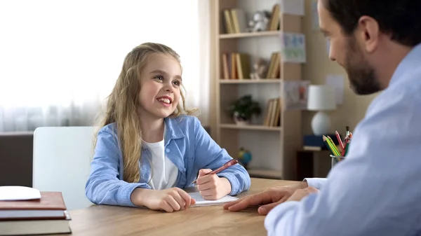 Smiling Little Daughter Sitting Table Doing Homework Father Care — Stock Photo, Image