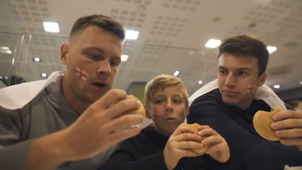 Russian Football Fans Eating Burgers Match Harmful Effect Fast Food — стоковое видео