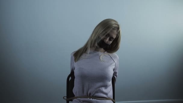 Unconscious Blond Woman Taped Mouth Sitting Chair Tied Ropes Kidnapping — Stock Video