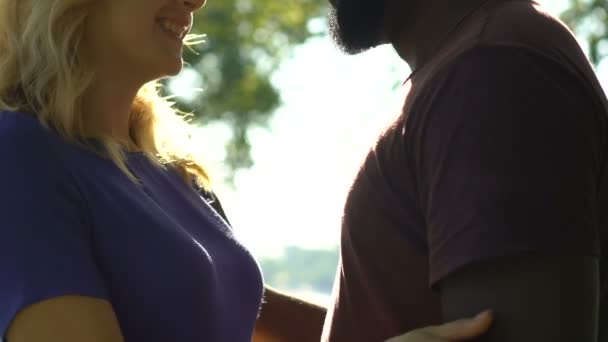 Young Multiracial Couple Smiling Hugging Park Romantic Date Side View — Αρχείο Βίντεο