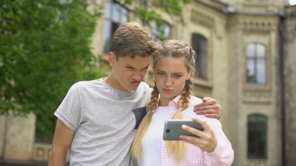 Teenager Using Cell Phone While Hugging Boyfriend Absorbed Social Networks  — Stock Video © motortion #231584390