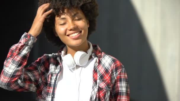 Pleased Curly Haired Woman Smiling Camera Adjusting Hairstyle Outdoors — Stock Video