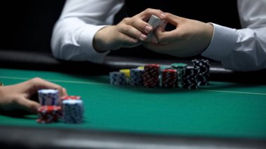 Profesyonel krupiye holding iskambil destesi ile casino istemci bahis yapmaya hazır