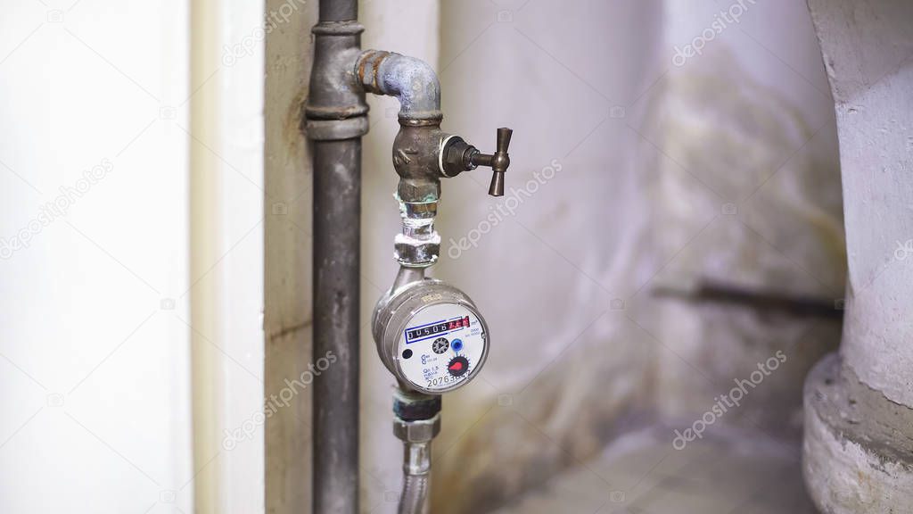Water-meter for controlling hot water consumption in house, utilities closeup