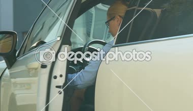 Beautiful lady boss getting out of expensive automobile and walking to office