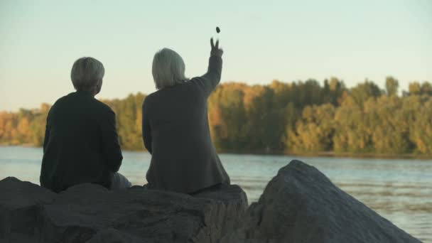 Two Elderly Women Sitting River Bank Park Throwing Meal Feed — Stock Video