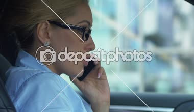 Angry business lady scolding colleague via cellphone, conflict at work, bad day