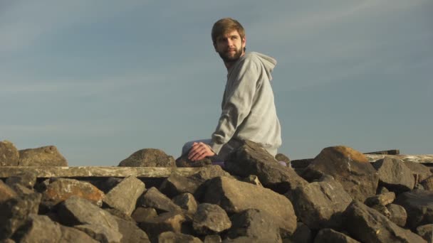 Young Pensive Man Looking Back Sitting Rocky Hill Analyzing Life — Wideo stockowe
