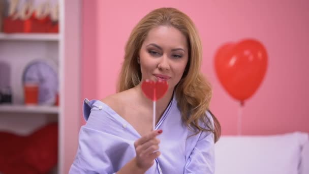 Seductive Blond Lady Closing Eye Heart Shaped Lollipop Smiling Camera — Stock Video