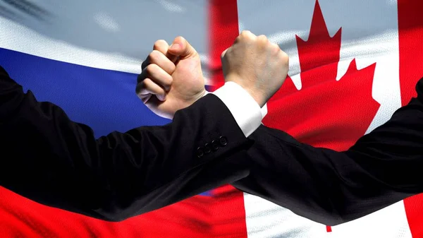 Rusland Canada Confrontatie Landen Onenigheid Vuisten Vlag Achtergrond — Stockfoto