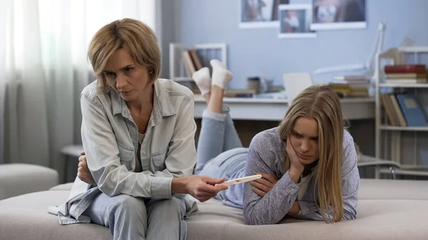 Mother Showing Found Two Strips Pregnancy Test Ashamed Teen Daughter — Stock Photo, Image