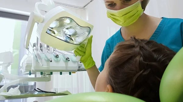 Female Pediatric Dentist Looking Child Patient Teeth Adjusting Light Cure — Stock Photo, Image