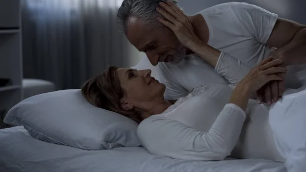 Elderly Couple Caressing Bed Man Kissing Woman Hand Love Marriage — Stock Photo, Image