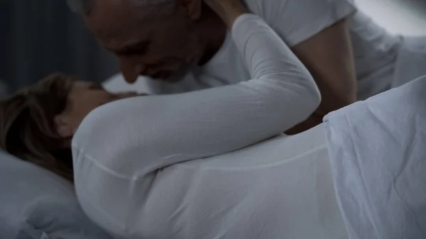 Elderly Man Caressing Woman Gently Male Female Lying Bed Hugging — Stock Photo, Image