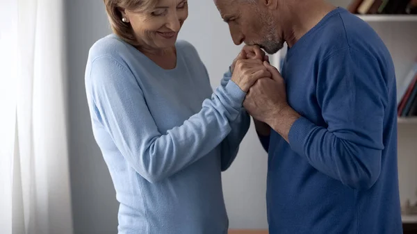Aging Male Holding Woman Hands Kissing Them Lady Feeling Shy — Stock Photo, Image
