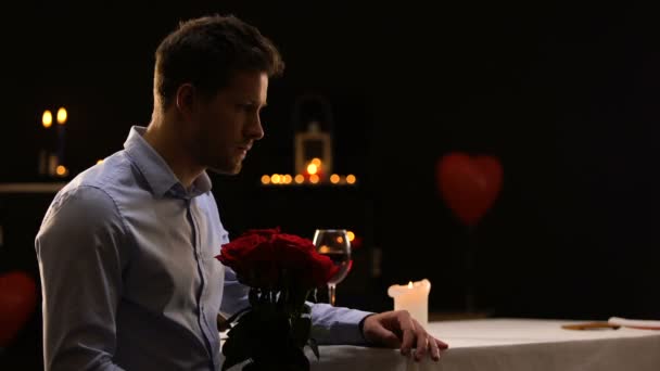 Anxious Male Blowing Out Candles Leaving Bunch Roses Unsuccessful Date — Stock Video
