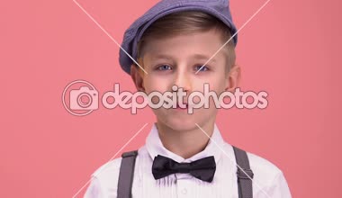 Retro giysiler, pembe arka plan izole kamera, bakarak akıllı çocuk