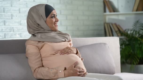 Happy Pregnant Woman Hijab Touching Belly Gently Resting Home Prenatal — Stock Video