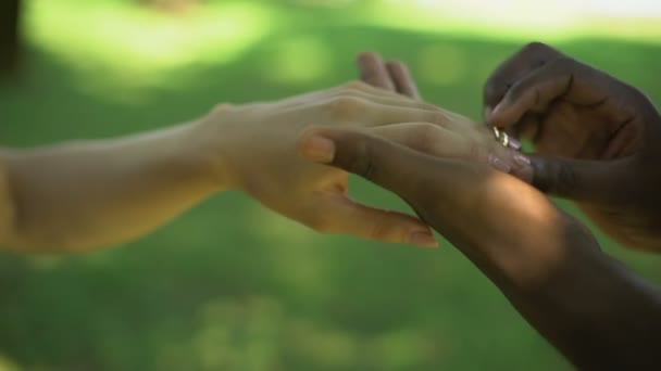 Casamento Multirracial Mão Masculina Coloca Anel Ouro Dedo Das Noivas — Vídeo de Stock