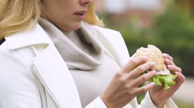 Hamburger yeme, mide bulantısı acı, hasta hissediyorum büyük göbek ile Genç Anne