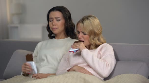 Female Friends Sitting Sofa Enjoying Sweet Chocolate Taste Hormones — Stock Video