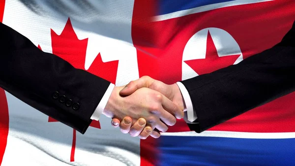 Canada Noord Korea Handdruk Internationale Vriendschap Vlag Achtergrond — Stockfoto
