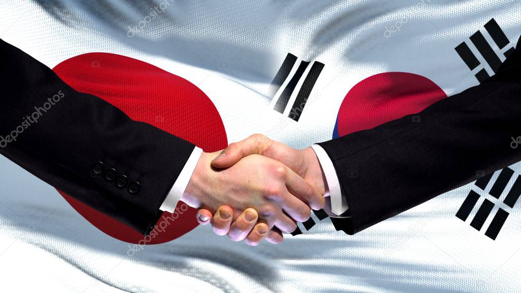 Japan and South Korea handshake international friendship summit, flag background