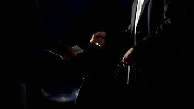Illicit drug trafficking, man in suit paying for drug package near car, darkness clipart