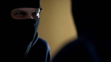 Aynada, saldırı yansıması bakarak siyah yüzü maskeli manyağı