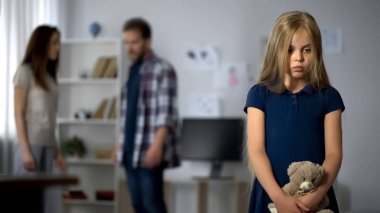 Upset girl witnessing act of domestic violence, suffering from parents conflicts clipart