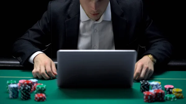 Gambling addicted businessman in front of laptop, losing sport bet, bankrupt