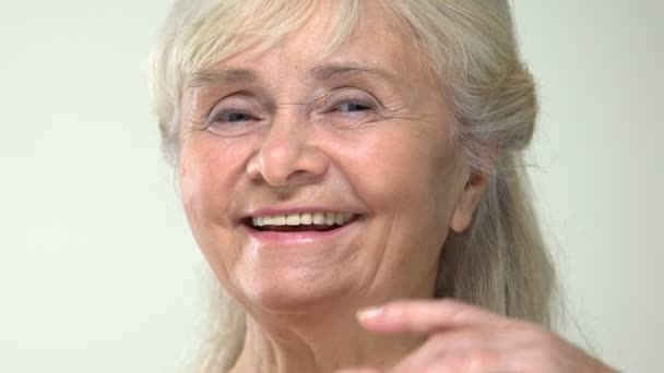 Happy Senior Female Touching Smooth Face Skin Moisturizing Cream Effect — Stock Video