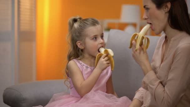 美丽的小公主和妈妈吃香蕉 健康的零食 — 图库视频影像