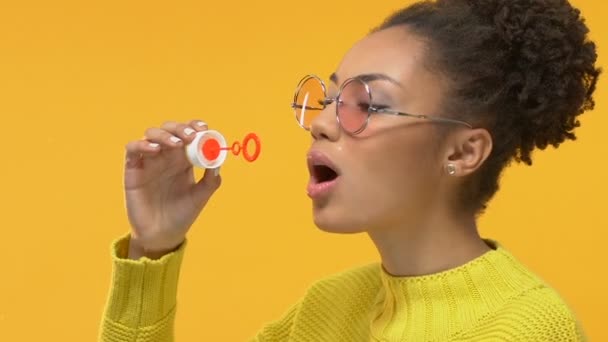 Joyful Black Woman Blowing Soap Bubbles Yellow Background Youth Happiness — Stock Video