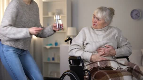 Young Lady Bringing Painkillers Grandmother Feeling Stomach Ache Health Care — Stock Video