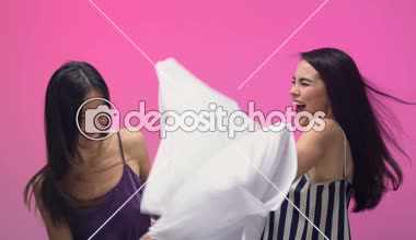 Pijama partisi üzerinde eğleniyor bayanlar yastık ile mücadele ve gülüyor, mo yavaş
