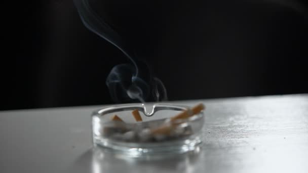 Filles main mettre la cigarette dans le cendrier sale plein de buts, addiction, mauvaise habitude 