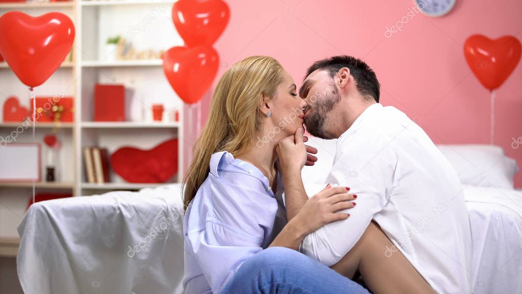Passionate man tenderly kissing lady after romantic night, sweet love relations