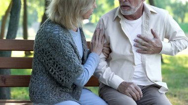 Senior man having heart attack during walk with wife, cardio problems healthcare clipart