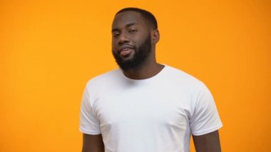 Ok işaret gösteren ve göz kırpıyor, müşteri gözden geçirme, hizmet flört Afro-Amerikan adam