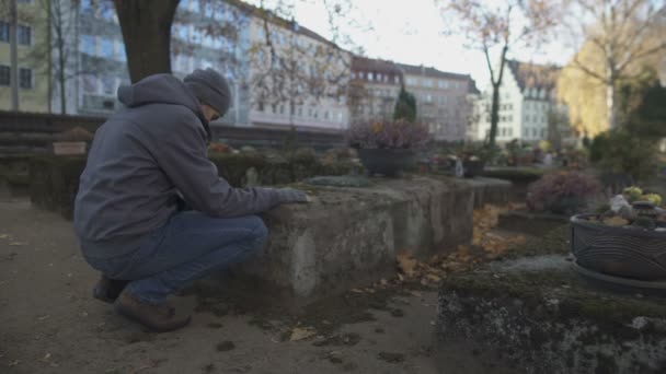 Young Man Sitting Grave Ancient Cemetery Praying Mourning Relatives — Stock Video