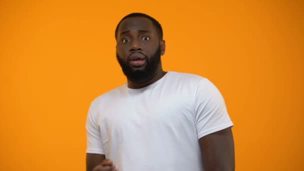 Ridiculous African American Man Feeling Fear Isolated Yellow Background — Stock Video