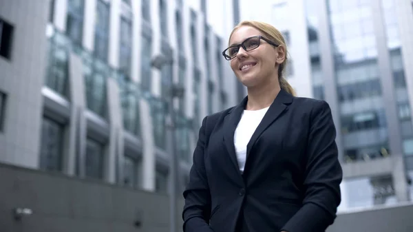 Friendly woman in suit meets foreign business partners, interpreter or hostess