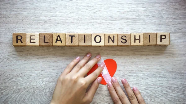 Relationship Word Wooden Cubes Female Hands Putting Patch Paper Heart — Stock Photo, Image