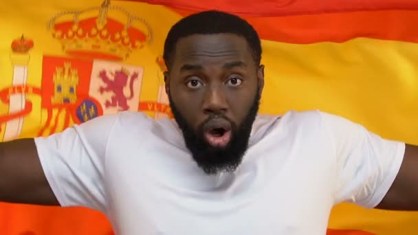 Excited Afro American Man Holding Spanish Flag Rooting Favorite Sport — Stock Video