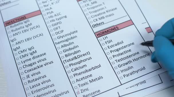 Growth hormone, doctor checking name in lab blank, showing blood sample in tube — Stock Video