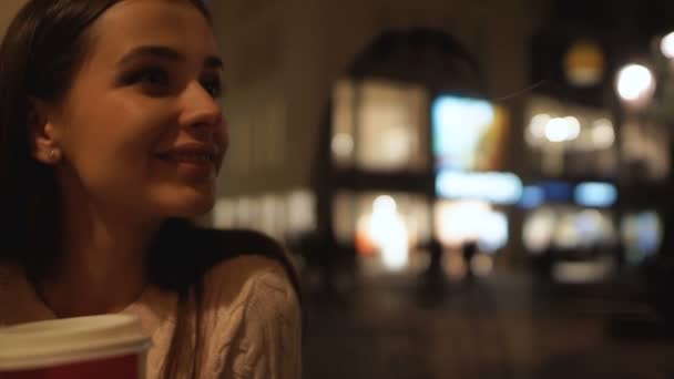 Schöne Brünette Kaffee trinken, wartenden Freund im Café, genießen die Nacht Stadt — Stockvideo