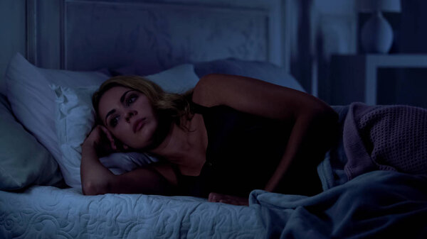 Pretty woman cannot sleep at night, overanxiety after stressful day, insomnia
